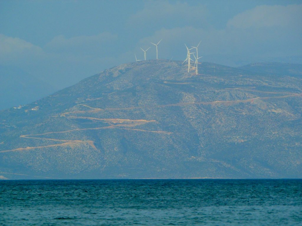 white sailboat on sea near mountain during daytime