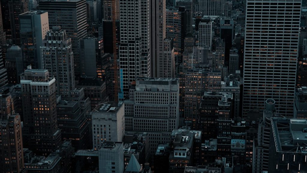 Dense cityscape with tall buildings at dusk.